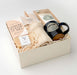new home present with special items like tea, soap, handmade ceramic mug, chocolate, and reusable shopping bag
